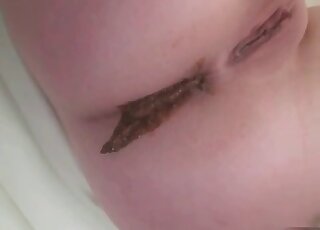 Middleaged woman with a shaved pussy showing off her holes