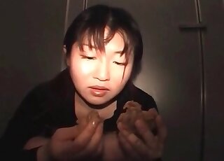Asian model with a pierced tongue is licking her poop